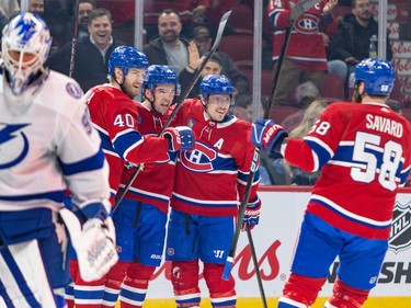 Tampa Bay Lightning goalie Matt Tomkins skates away as Canadiens players celebrate a goal