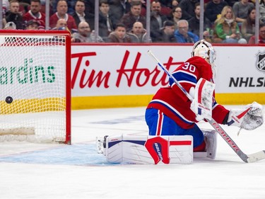 Montreal Canadiens' Cayden Primeau looks back at a puck in the net