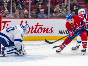 Montreal Canadiens' Brendan Gallagher takes a shot on Tampa Bay Lightning goalie Matt Tomkins while being pursued by Tanner Jeannot