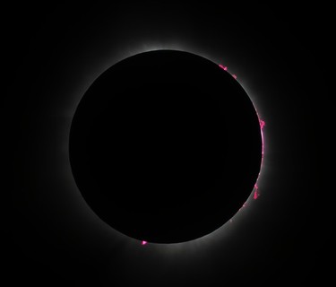 The sun is blocked out during the totality phase of a solar eclipse in a closeup shot.
