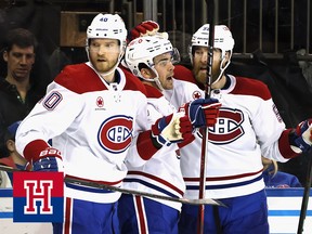 Three Montreal Canadiens players celebrate a goal together