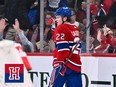 Cole Caufield skates away after scoring a goal as Montreal Canadiens fans cheer behind the glass