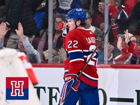 Cole Caufield skates away after scoring a goal as Montreal Canadiens fans cheer behind the glass
