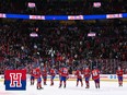 Montreal Canadiens players gather on the ice and raise their sticks to acknowledge the home crowd at the Bell Centre
