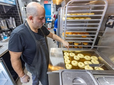 Terry Axiotis tends to doughnuts in a deep fryer