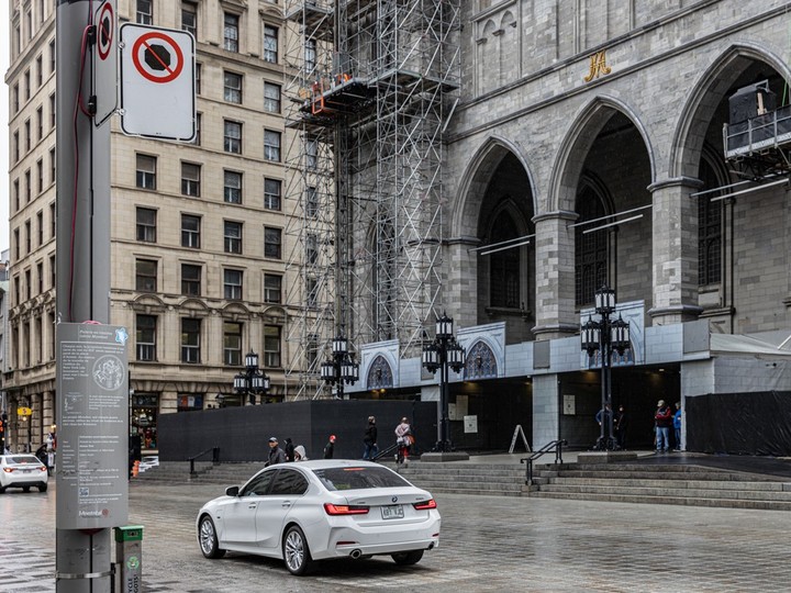  A driver in a white BMW waits in a no-stopping zone in front of the Notre-Dame Basilica in Old Montreal on April 11, 2024.