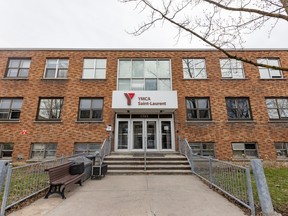 The front of a brick building has a sign over the front door reading YMCA Saint-Laurent.