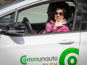 Montreal Mayor Valerie Plante arrives for a press conference at the wheel of a Communauto in Lachine on Monday. The ride-sharing firm envisions more cars at REM stations this year as part of its continuing expansion..