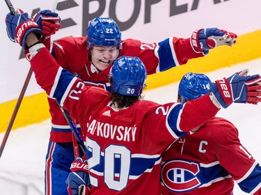 Canadiens Cole Caufield and Juraj Slafkovsky extend their arms while facing each other