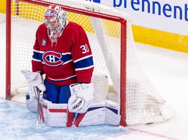 Canadiens goalie Cayden Primeau lowers his head while on his knees deep in his crease
