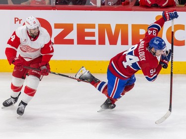 Canadiens' Logan Mailloux falls forward as Red Wings' Robbie Fabbri hooks his stick under Mailloux's leg