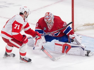 Montreal Canadiens' Cayden Primeau makes a save on a shot by Detroit Red Wings' Dylan Larkin