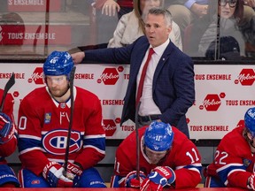 Canadiens head coach Martin St. Louis stands behind Joel Armia, left, and Brendan Gallagher during season finale Tuesday night at the Bell Centre.