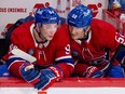 Montreal Canadiens defencemen Justin Barron, right, and Logan Mailloux talk on the bench