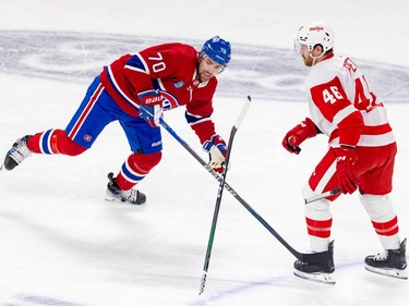 Jeff Petry holds the end of a broken stick while the rest flies upside down and Canadiens' Tanner Pearson skates through