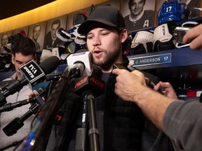 Josh Anderson is seen in the Canadiens' dressing room surrounded by a phalanx of reporters' microphones.