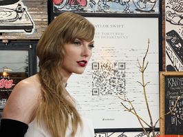 Composite photo of Taylor Swift in a white dress and a large QR code on the side of a building
