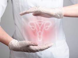 A person in white, with white gloves holds their hands around an illustration of a uterus on their abdomen.