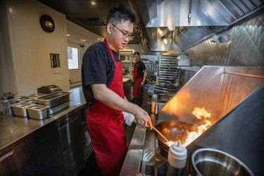 Chef Anderson Lee works the wok at Oncle Lee restaurant in Mile End on Thursday, April 18, 2024.