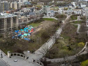 An aerial view of dozens of tents on a grassy area of the McGill University campus downtown
