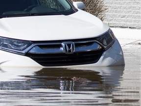 A car is submerged during flooding in Quebec in 2019.