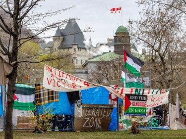 Banners are seen along a temporary fence with a McGill University building in the background