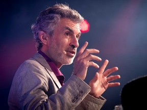 Yoshua Bengio gestures while speaking at a conference