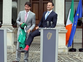 Prime Minister Justin Trudeau is presented with an Ireland rugby union shirt and a pair of socks in 2017 by Irish Taoiseach Leo Varadkar in Dublin.