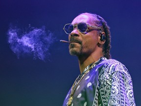 Snoop Dogg smoking a joint on stage