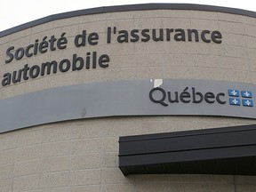 A building with a sign for the SAAQ on its side