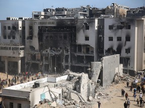 Palestinians inspect the damage at Gaza's Al-Shifa hospital after the Israeli military withdrew from the complex housing the hospital on April 1, 2024, amid the ongoing battles Israel and the Hamas militant group.