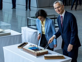 NATO Secretary General Jens Stoltenberg (R) and Belgian Foreign Minister Hadja Lahbib (L) cut a commemorative cake during the alliance's 75th anniversary celebrations at NATO Headquarters on April 4, 2024 in Brussels, Belgium.