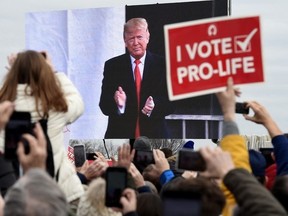 Pro-life demonstrators listen to U.S. President Donald Trump as he speaks at the 47th annual "March for Life" in Washington, DC, on Jan. 24, 2020.