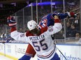 The Canadiens' Michael Pezzetta, wearing the Montreal's road red jersey, is seen falling backward after colliding with the Rangers' Matt Rempe Sunday night at Madison Square Garden.