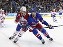 Canadiens' Justin Barron, left, battles Rangers' Chris Kreider in the Montreal zone during game in New York on Sunday.
