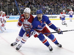 Canadiens' Justin Barron, left, is seen shoulder-to-shoulder with Rangers' Chris Kreider as they head into a corner and right into the camera frame during game in New York on Sunday.