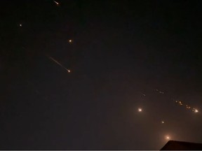 This video grab from AFPTV taken on Sunday, April 14, 2024, shows explosions lighting up the sky in Hebron, Palestinian Territories, during an Iranian attack on Israel.