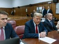 Former U.S. president Donald Trump appears with his legal team ahead of the start of jury selection at Manhattan criminal court on April 15, 2024 in New York City.