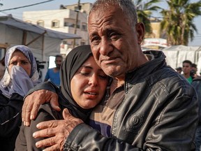 Palestinians mourn the death of loved ones following Israeli bombardment in Maghazi on Tuesday.