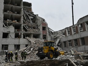 Ukrainian rescuers clear the rubble of a destroyed building following a missile attack in Chernigiv on April 17, 2024, amid the Russian invasion of Ukraine.