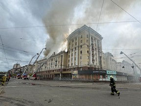 Ukrainian rescuers try to extinguish a fire in a residential building following a missile attack in Dnipro on April 19, 2024, amid the Russian invasion of Ukraine.