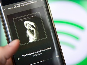 This photograph taken in Paris on April 19, 2024, shows a smartphone displaying singer-songwriter Taylor Swift's new album, The Tortured Poets Department, on Spotify.
