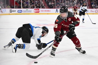 Maureen Murphy #15 of Montreal skates the puck past Brittany Howard #41 of Toronto during second-period PWHL action at the Bell Centre on April 20, 2024 in Montreal.