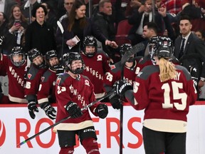 Montreal's Erin Ambrose, wearing her home burgundy jersey, is seen screaming with joy in front of her team's bench and facing teammate Maureen Murphy, right, after scoring a goal Saturday at the Bell Centre.