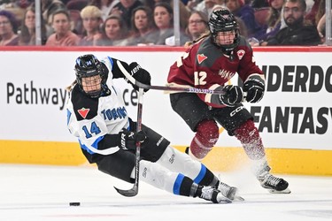 Renata Fast #14 of Toronto slips as she skates the puck past Claire Dalton #42 of Montreal during the third-period PWHL action at the Bell Centre on April 20, 2024 in Montreal.