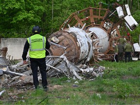 A Ukrainian police investigator examines debris at the Kharkiv Television Tower, after officials reported a Russian strike on the tower, on the outskirts of Kharkiv on April 22, 2024.