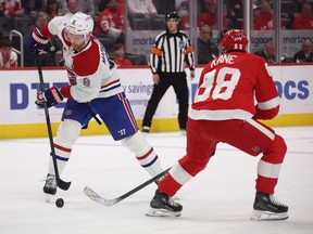 Canadiens' Mike Matheson tries to control the puck behind Wings' Patrick Kane during first-period action at Little Caesars Arena in Detroit Monday night.