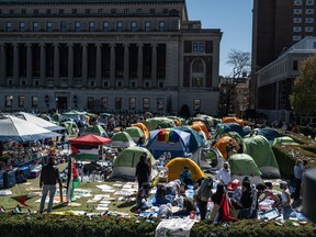 Columbia University students participate in an ongoing pro-Palestinian encampment on their campus following last week's arrest of more than 100 protesters on April 23, 2024 in New York City.
