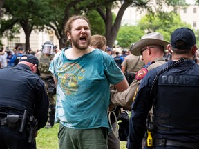 A person is detained by police as pro-Palestinian students protest against the Israel-Hamas war on the campus of the University of Texas in Austin, Texas, on April 24, 2024.