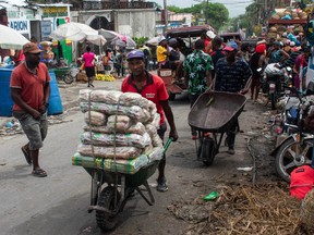 Vendors and pedestrians walk through the street in Port-au-Prince, Haiti, on April 26, 2024.